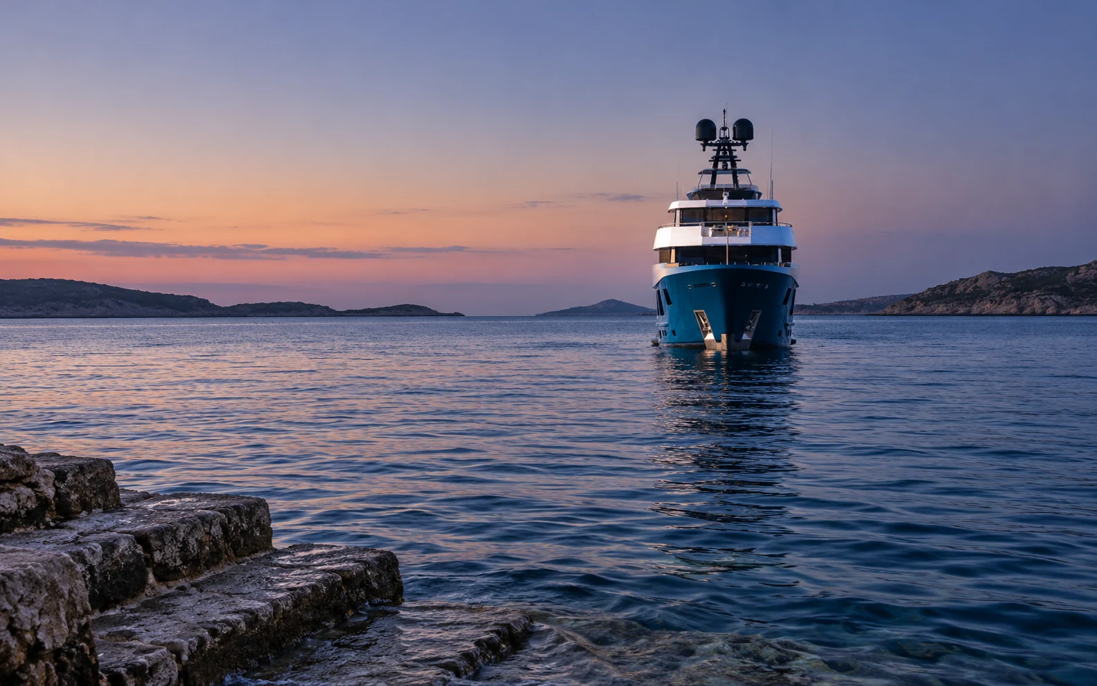 KING BENJI at anchor at dusk, lights on