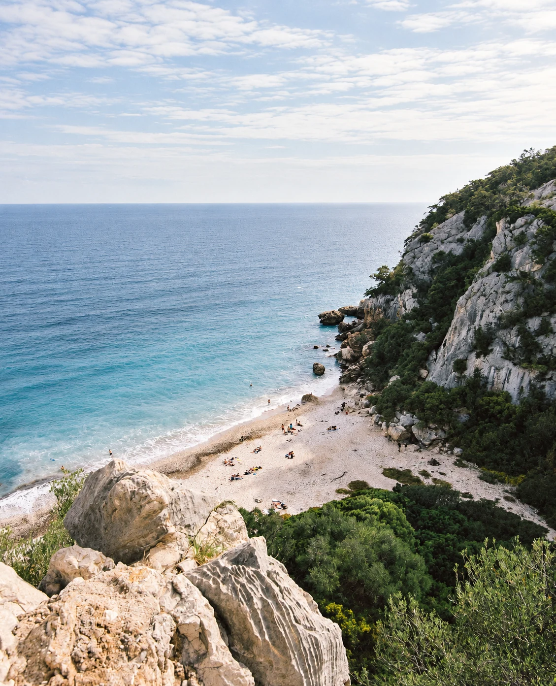 A white-sand cove below limestone cliffs